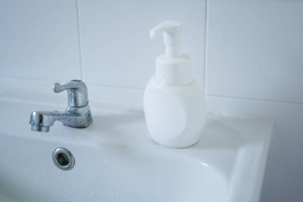 White wash basin and soap dispenser in the bathroom