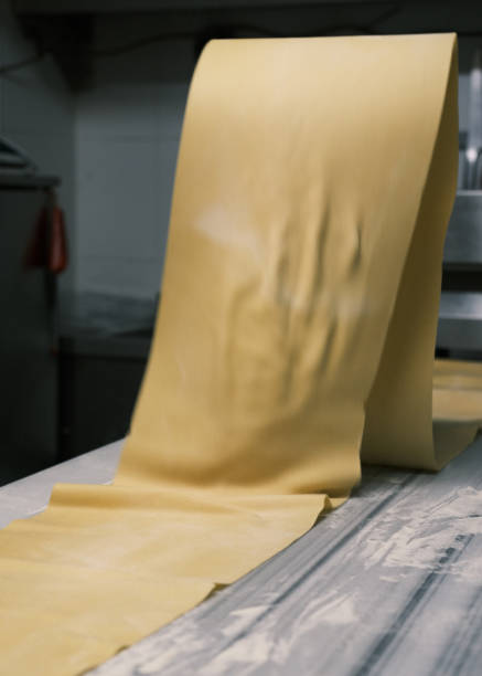 istock Freshly rolled sheet of handmade pasta on a floured surface in an Italian restaurant kitchen, traditional pasta-making process with smooth dough for authentic Italian cuisine 2198102412