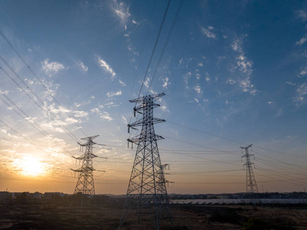istock Sunset silhouette of high voltage transmission lines 2198106039