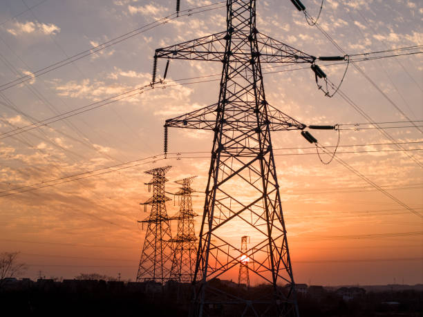 istock Sunset silhouette of high voltage transmission lines 2198106083