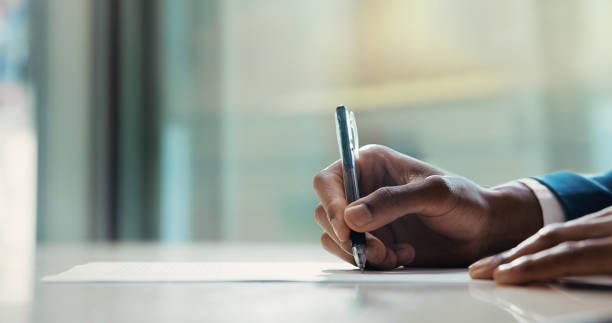 istock Business document, hands or writing on contract for signature agreement, application or policy information. Professional, person and legal paperwork for recruitment compliance or terms and conditions 2198106760