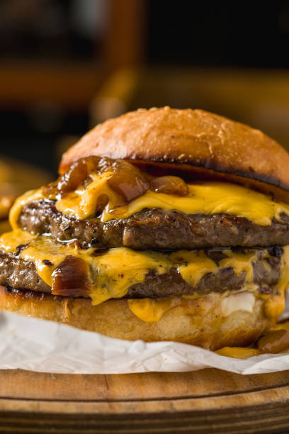 istock Smash burger with cheddar cheese and caramelized onions, served with fries 2198108189