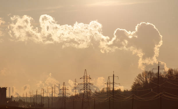 A cloudy sky with a large cloud that looks like a person. The sky is filled with power lines and the clouds are low to the ground