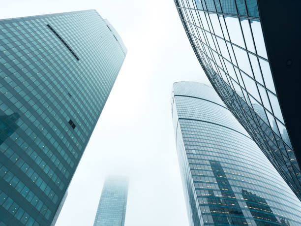 istock Three tall buildings with many windows and a cloudy sky in the background 2198110300