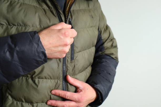istock man zipping up winter jacket 2198111164
