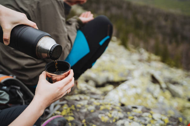 istock A photographer pouring coffee from a thermos into a cup 2198112279
