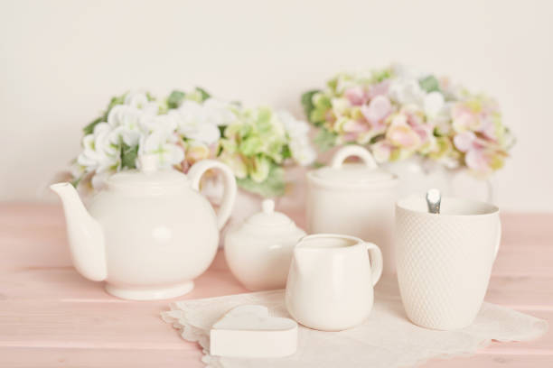 istock Set of white dishes on table on light background 2198113663
