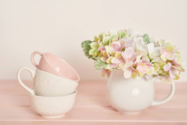 Set of white dishes on table on light background.