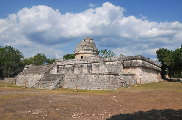 Chichen Itza, Mexico- May 17, 2013:  The ancient city of Chichen Itza is located in the state of Yucatan, eastern Mexico. it is one of the most important city-states in pre-Hispanic America and one of the New 7 Wonders of The World according to UNESCO. The main Mayan Ruin is the Chichen Itza Pyramid or El Castillo, but there are other equaly important as El Caracol or Observatory, The Temple of The Warriors and the Mayan Ball Game. Here is the Observatorio (The Observatory).