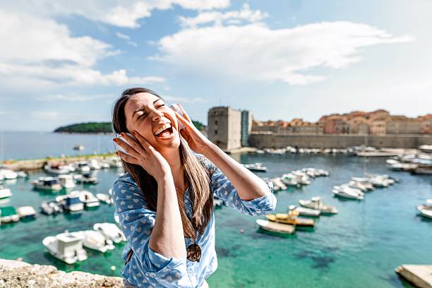 istock Young woman enjoying dubrovnik harbor view 2198114711