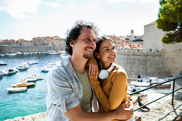 istock Smiling couple enjoying dubrovnik harbor view 2198115003