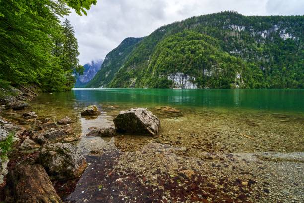 istock Serene lake surrounded by lush green mountains. 2198118569
