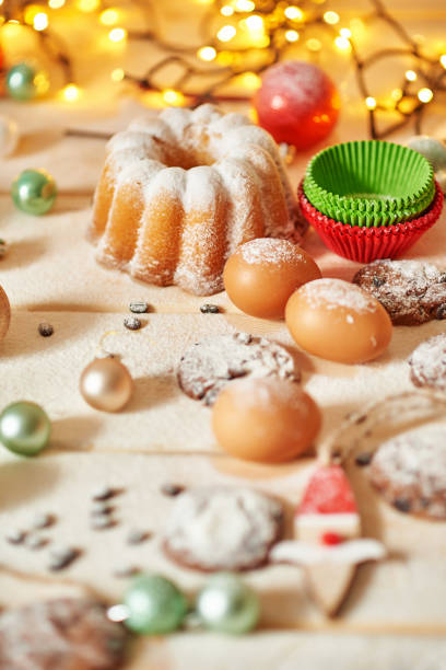 Christmas cake and sweets on table. Christmas decorations with lights background. Happy New Year! Christmas greeting card. Winter card template. Xmas concept. Holiday Banner. Feast of Nativity
