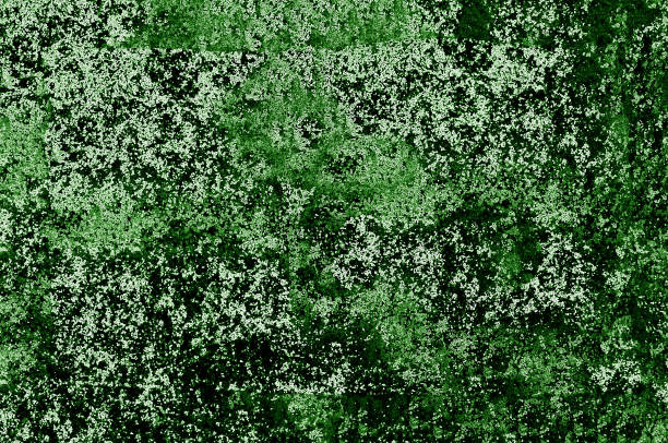 Abstract grunge background with green and dark spots on the surface close-up