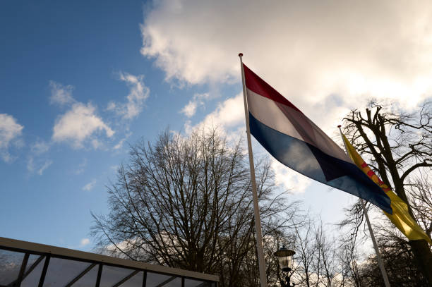 istock Netherlands flag waving against blue sky 2198123324