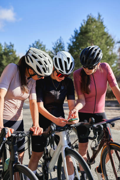 istock Female cyclists checking a smartphone during a ride 2198123388