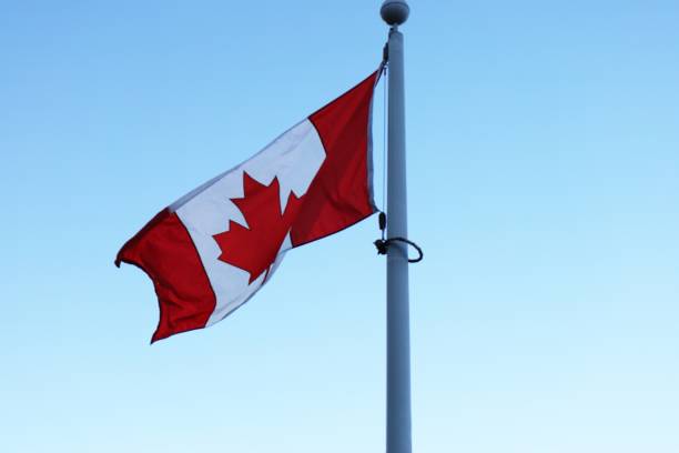 Canada flag waving mast on white background with clipping path.