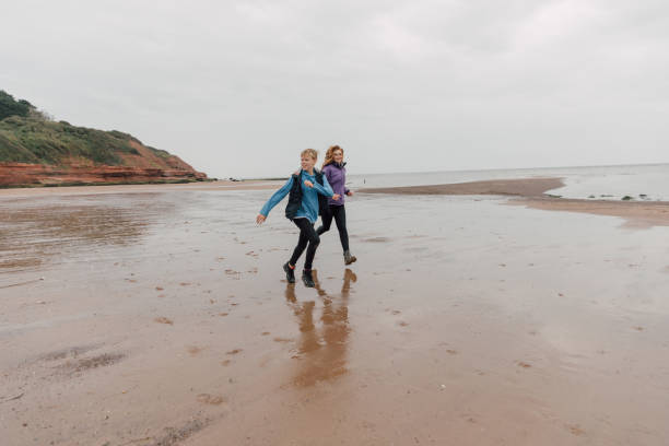 istock Brother and sister playing in a beach 2198123819