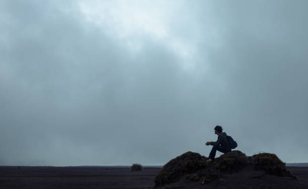 One Chinese man travels on Bromo Volcano plain, at Surabaya, East Java, Indonesia, during January winter