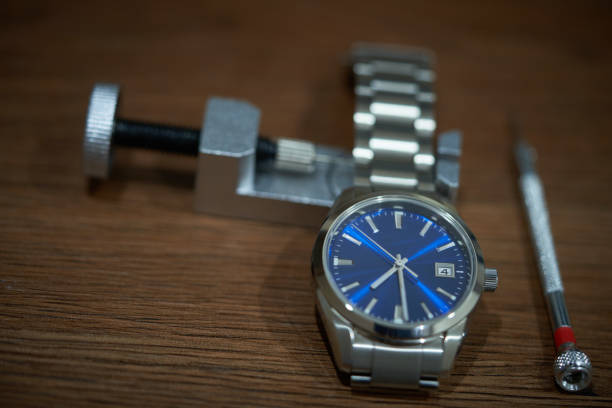 A gold wristwatch - focus is on the hour and minute hands.