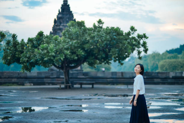 One Chinese woman enjoying the beautiful view of Candi Prambanan in Yogyakarta, Java, Indonesia