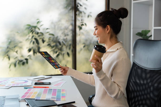 istock Graphic designer enjoying coffee while selecting color palettes in a bright workspace 2198124550