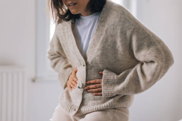 istock Young woman with stomach ache 2198124792