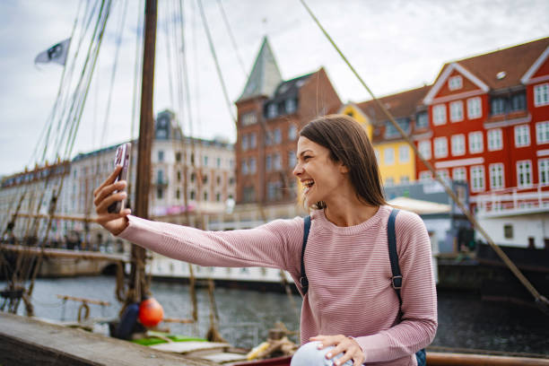 istock Young woman taking selfie in copenhagen harbor 2198129320