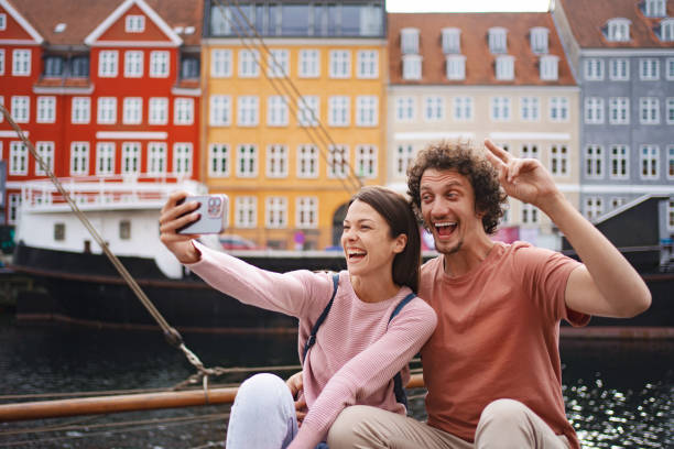 istock Happy young adults taking selfie in copenhagen 2198129425