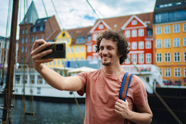 istock Young man taking selfie in nyhavn, copenhagen 2198129428