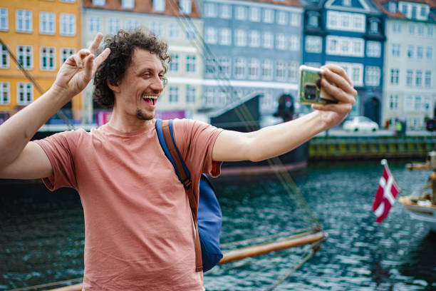 istock Young man taking selfie in iconic copenhagen 2198129454