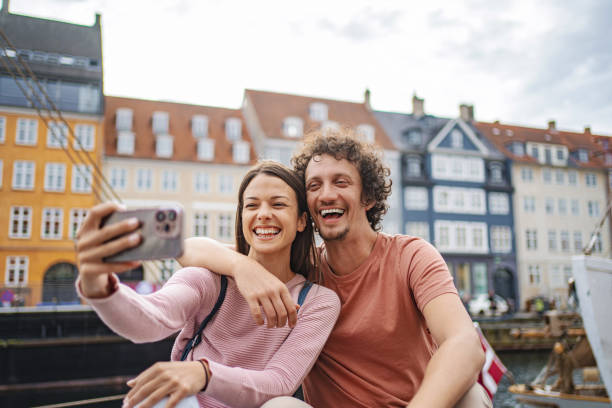 istock Smiling couple taking selfie in copenhagen 2198129492