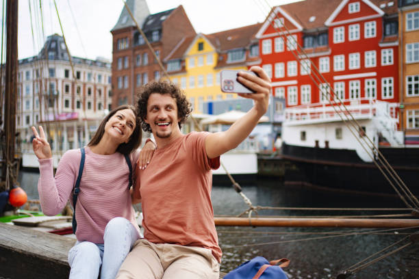 istock Smiling couple taking selfie by colorful buildings 2198130147