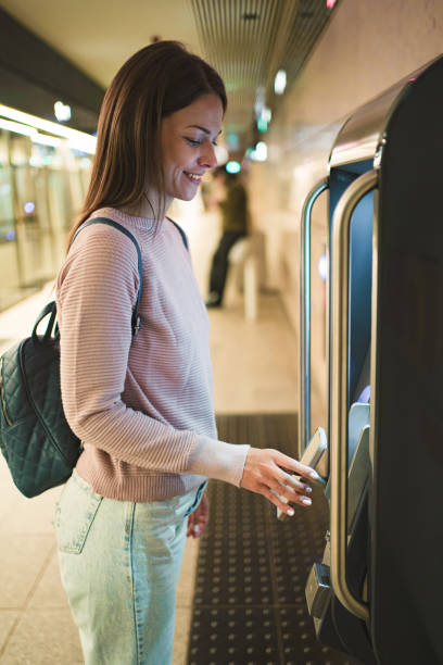 istock Young woman using ticket machine in copenhagen 2198130201
