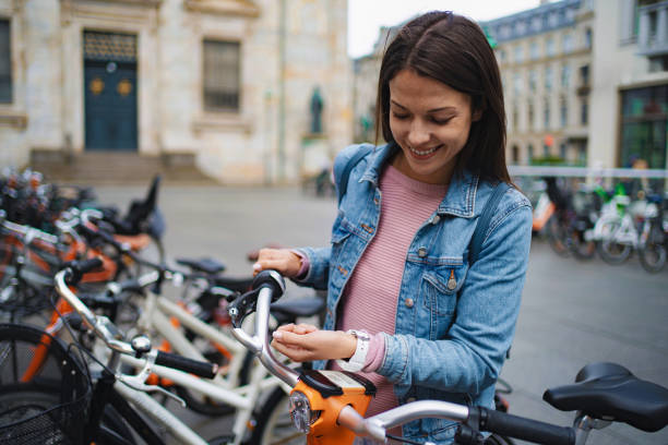 istock Young adult woman checking smartwatch while biking 2198130234
