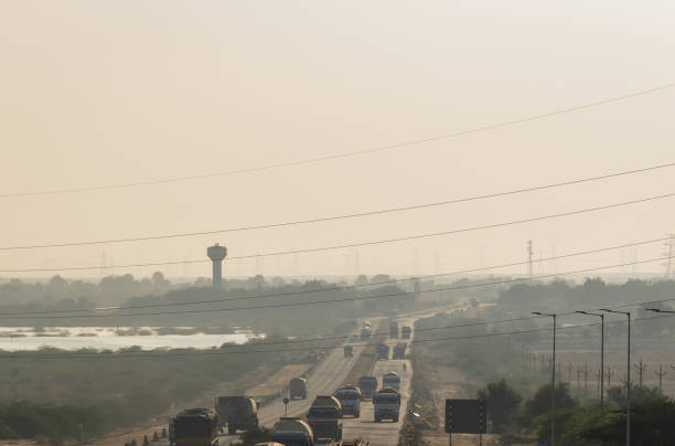 istock highway with traffic at hazy evening near city 2198130295