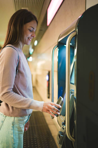 istock Young adult woman using ticket machine in copenhagen 2198130340