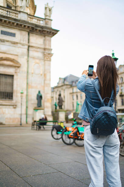 istock Young woman capturing copenhagen architecture on phone 2198130380