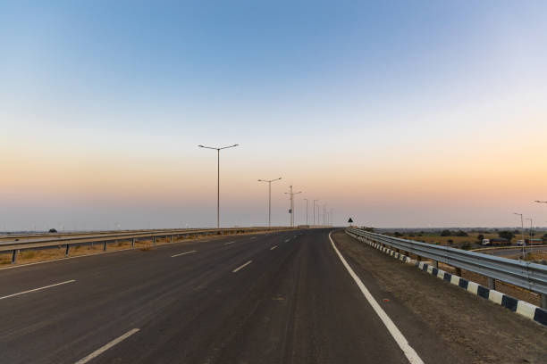 istock isolated empty tarmac road with bright sunset sky at evening 2198130511
