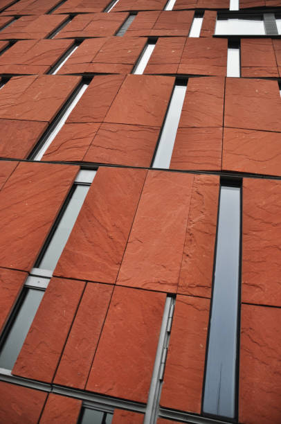 istock Red brick facade with narrow windows of a modern building, modern architecture 2198130530