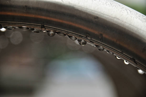 Wet metal frame structure with hoops, raindrops on the bike rack