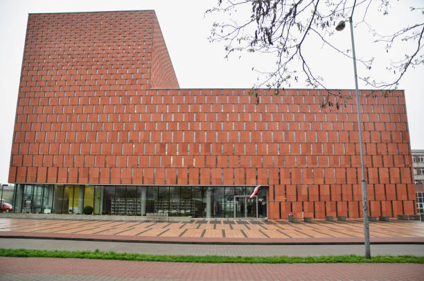 Red brick facade with narrow windows of a modern building, modern architecture