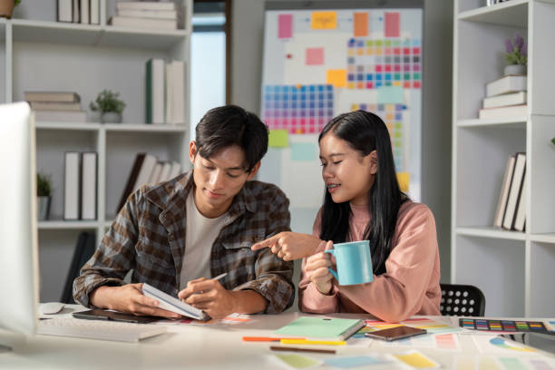 istock Diverse graphic design team collaborating and brainstorming in a creative workspace. 2198130871