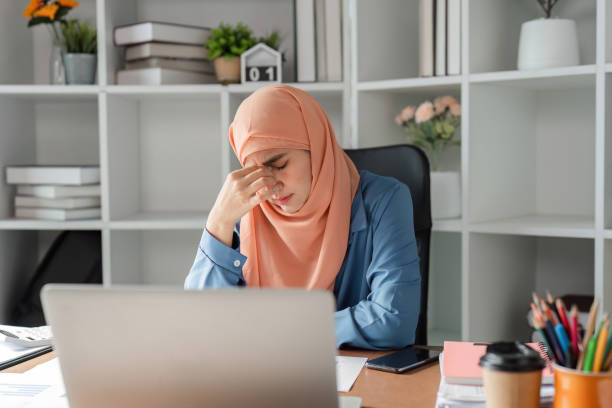 istock Diverse Muslim woman distressed while working on financial reports in office. 2198131374
