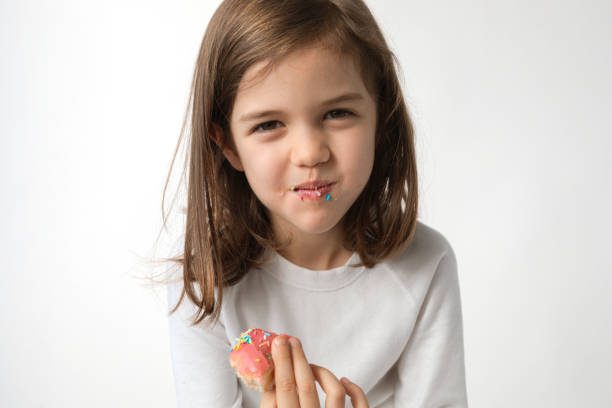 Cute funny little girl toddler child eating pink cake and laughing large portrait
