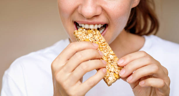 istock Woman eating protein bar. Healthy diet. 2198135009