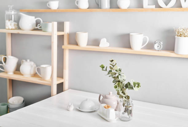 istock Tableware and decorations for serving festive table on light background.Shelves with utensils. 2198135596