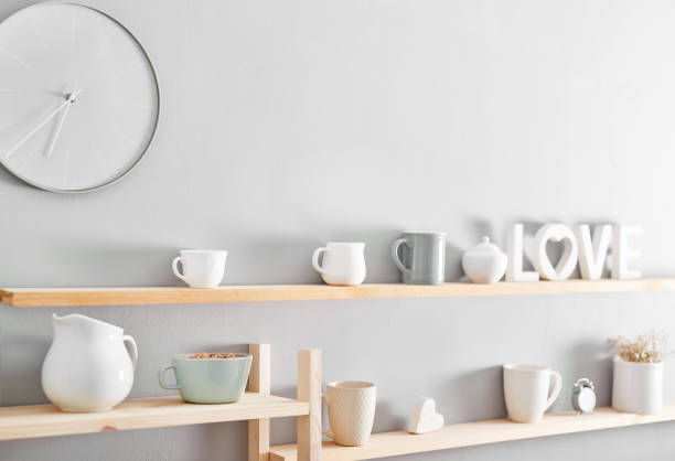 istock Utensils and mugs on shelf. Dishes in cupboard in kitchen. 2198135667