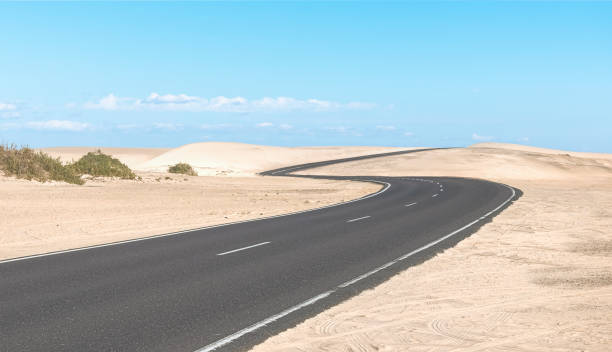 istock Road on a desert landscape at a sunny day 2198139277