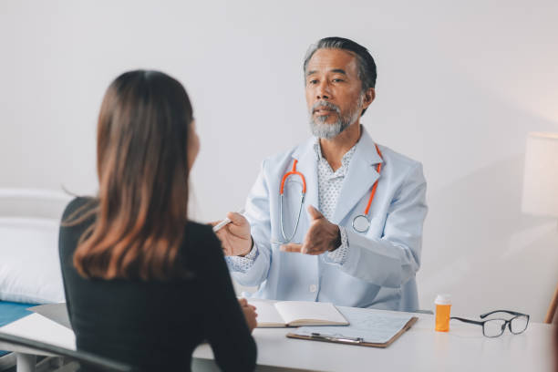 istock Doctor discussing with patient in hospital 2198140147